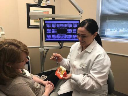 dentist helping patient in office